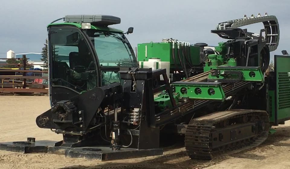 A compact directional drill on tracks in the yard