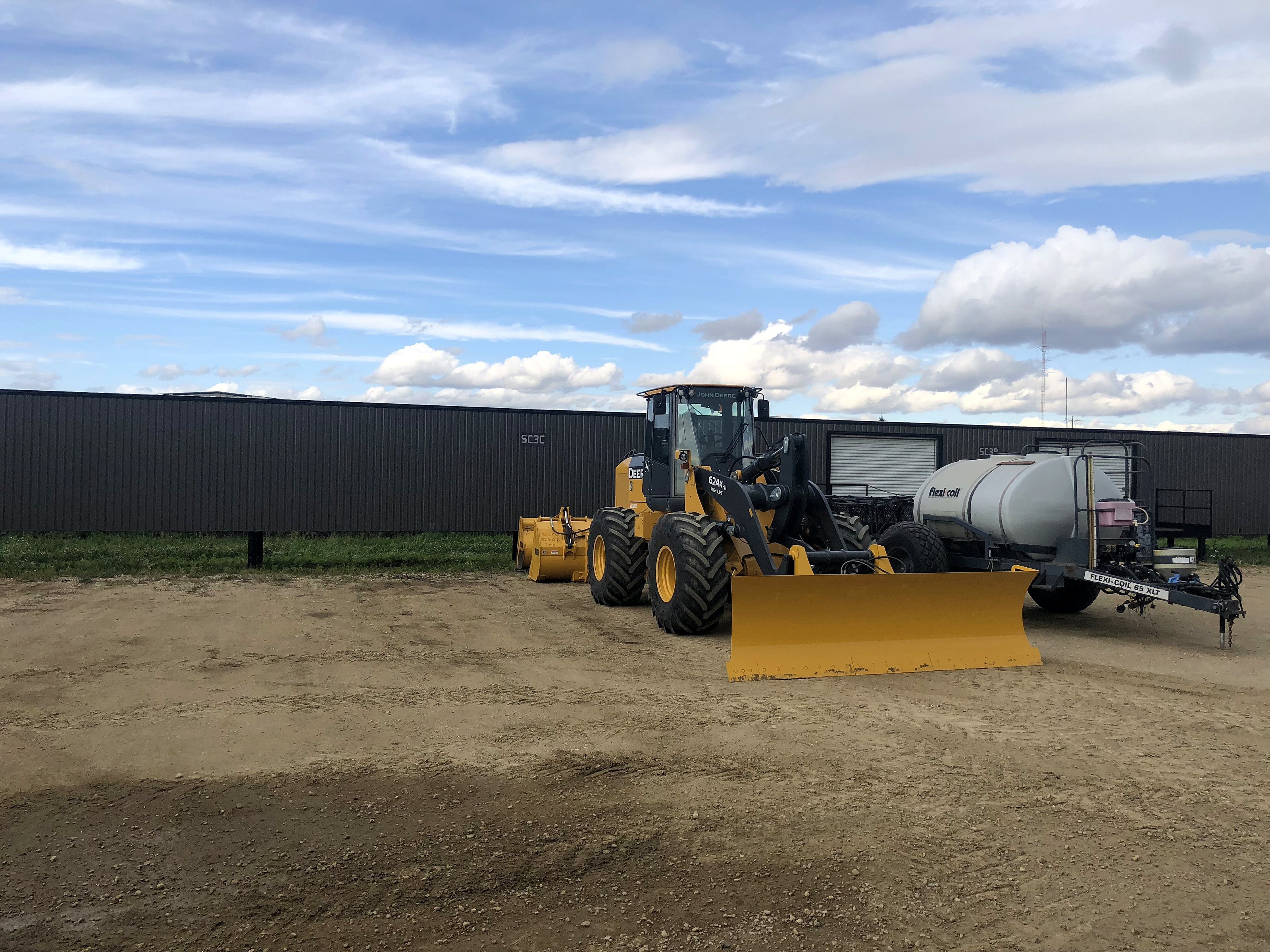A wheel loader at the feedlot with a bucket on