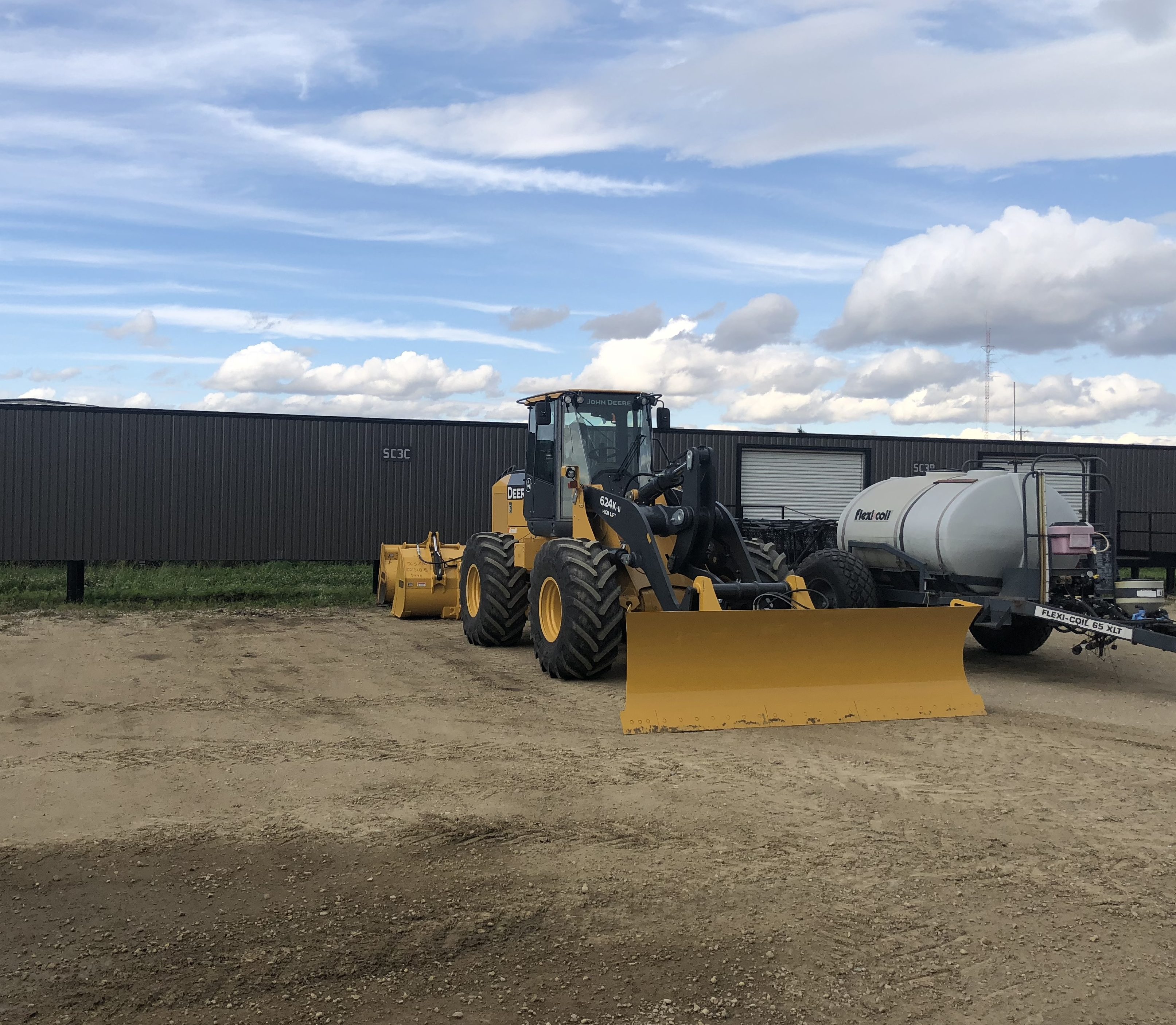 A wheel loader at the feedlot under a big sky