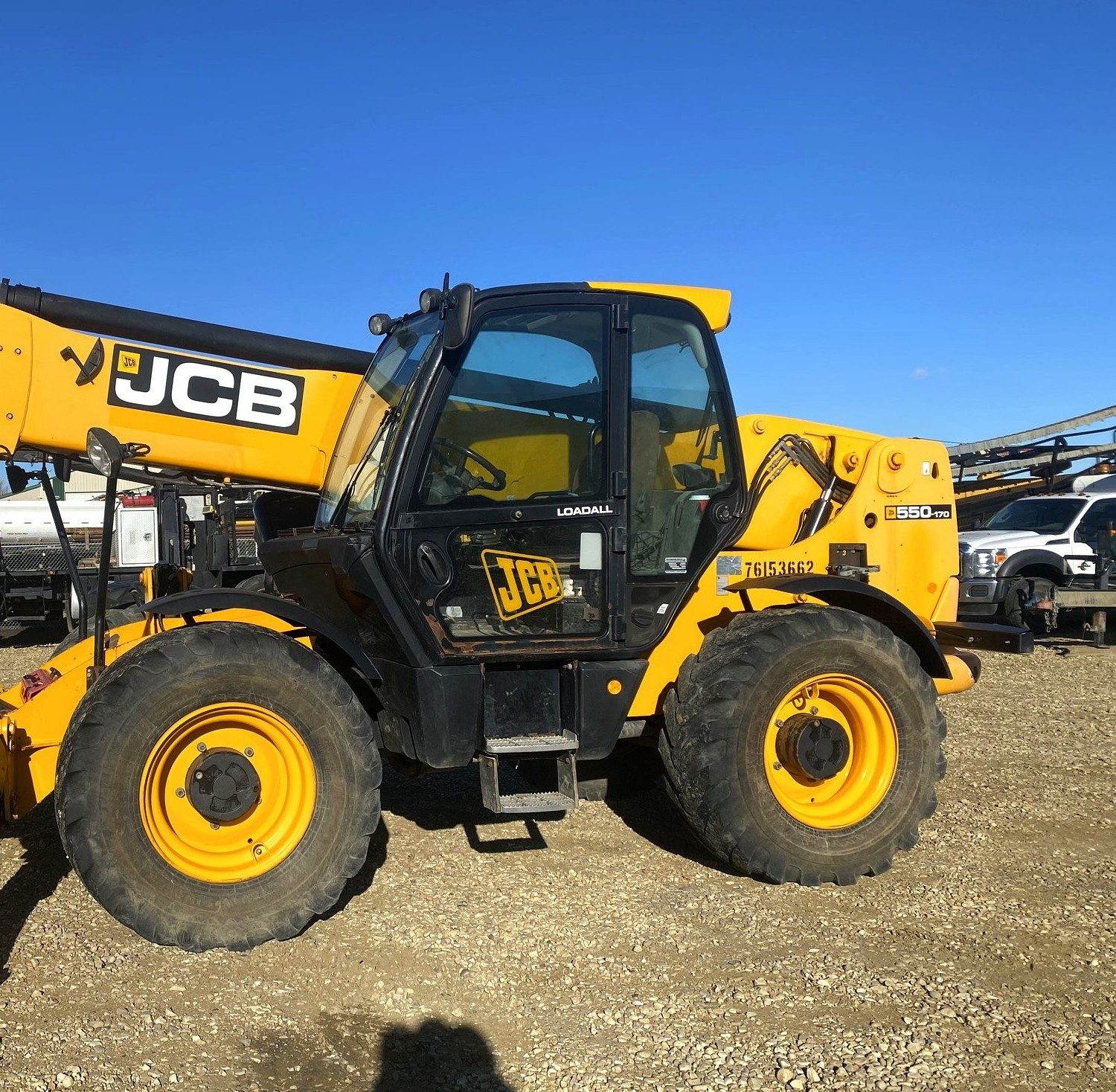 A telehandler in the yard with its boom down
